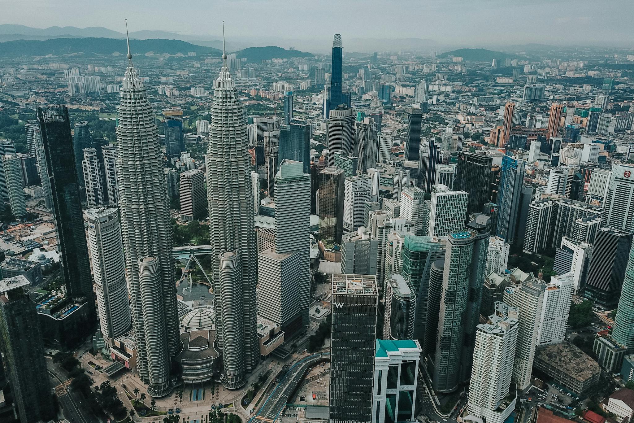 Breathtaking aerial view of Kuala Lumpur's skyline featuring the iconic Petronas Towers.